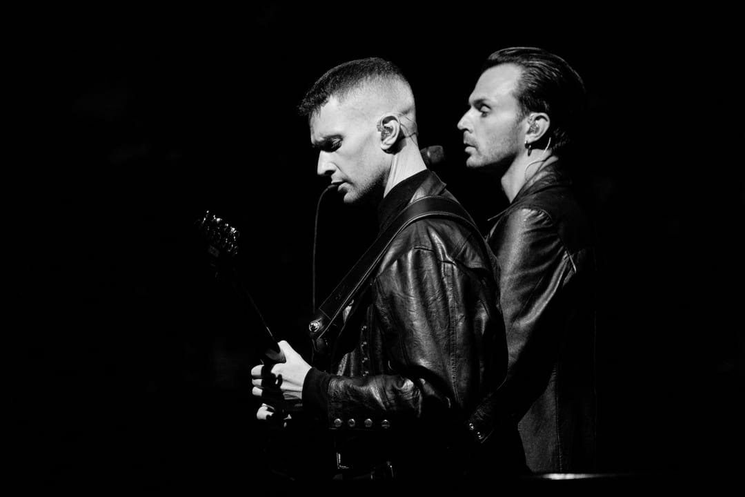 Hurts on stage, lit from behind